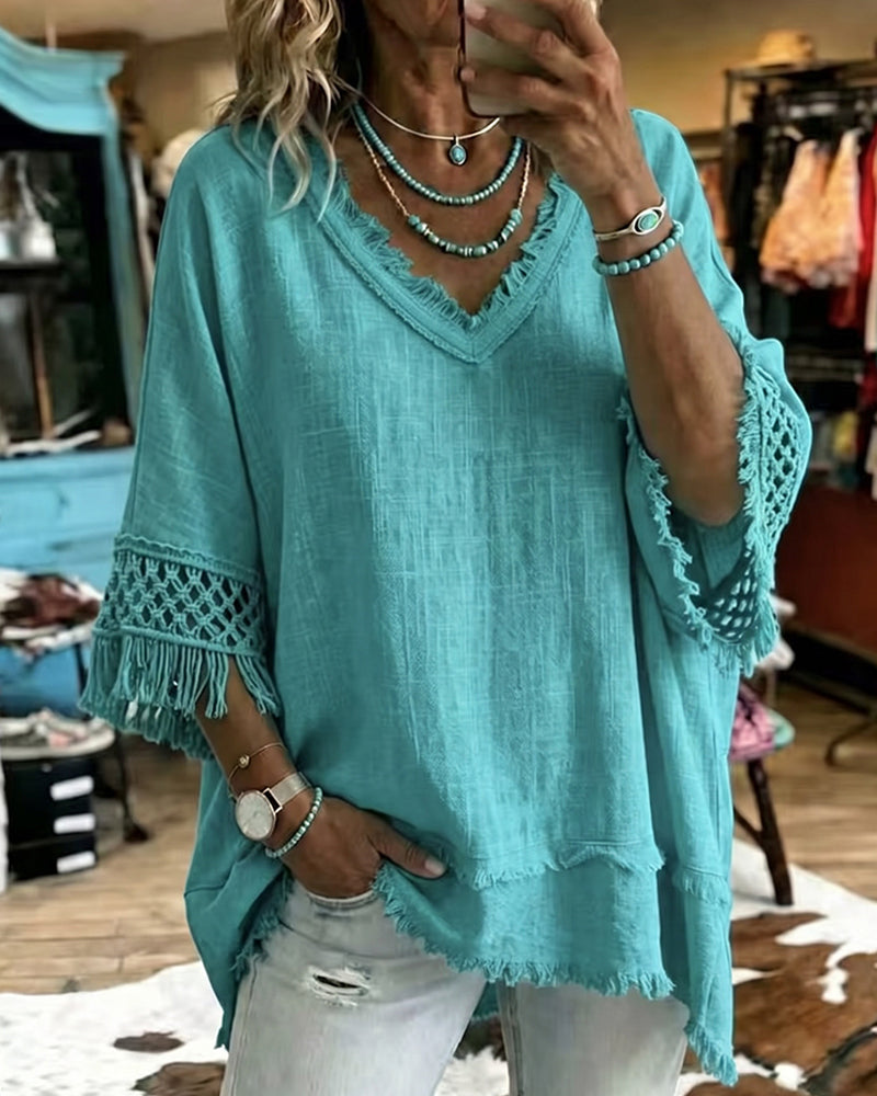 Front view of the Kaelani bohemian blouse in blue, showcasing the V-neck and crochet fringe trim sleeves.