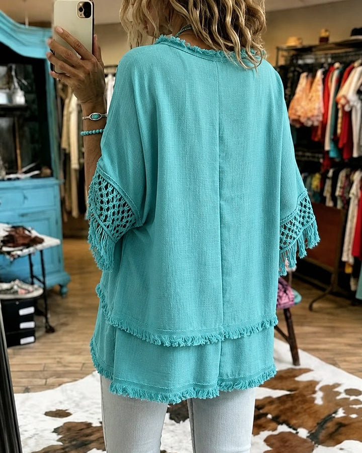Side profile of the Kaelani blouse, highlighting the raw edge design and comfortable fit in a resort-inspired look.