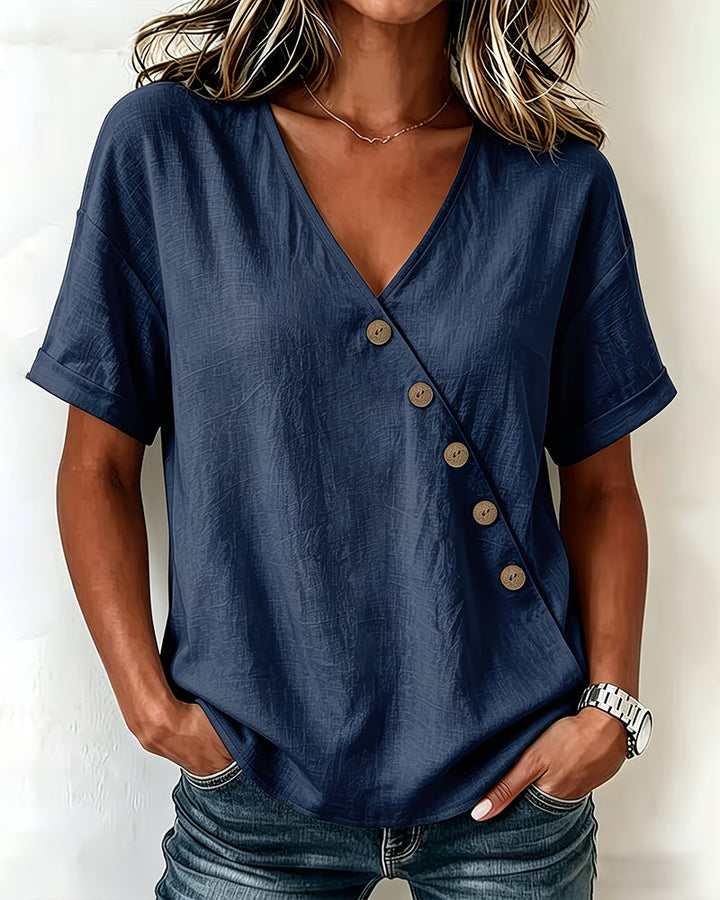 Side profile of the brown asymmetrical button blouse, highlighting the relaxed drop shoulder design.