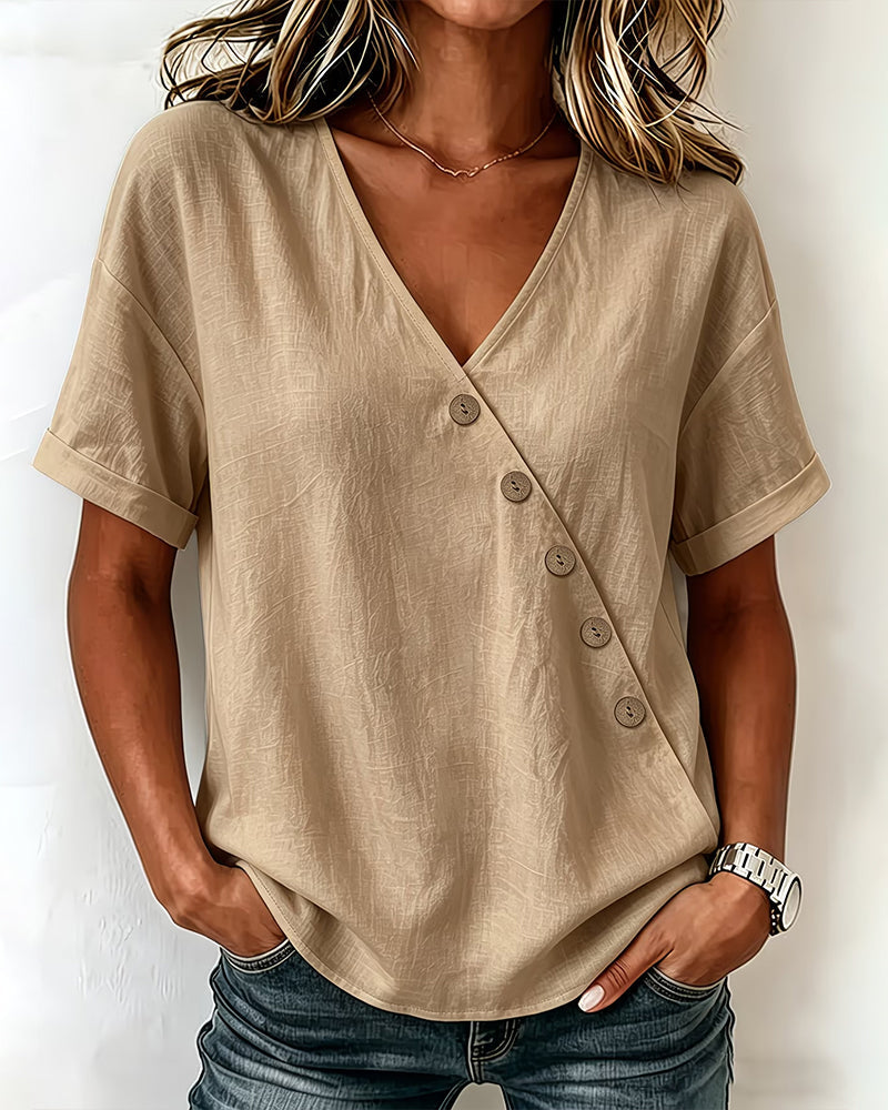 Detailed fabric texture of the black asymmetrical button blouse, emphasizing its lightweight feel.