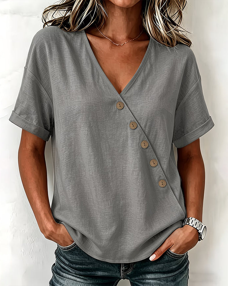 Back view of the caramel asymmetrical button blouse, showing the simple, elegant drape of the fabric.