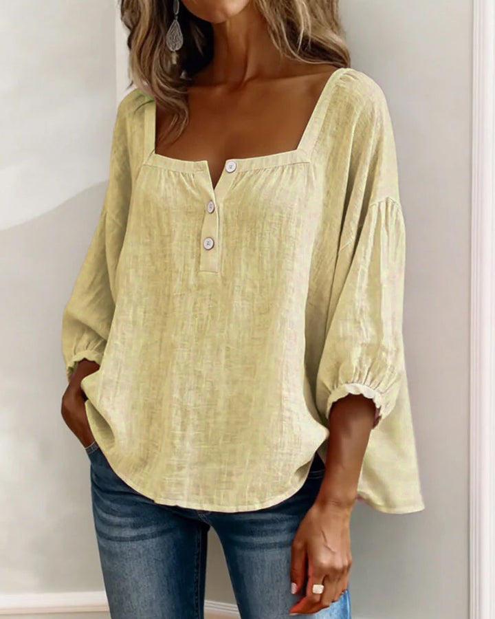 Detail of the stitching and finish around the square neck of the blue Anya blouse.