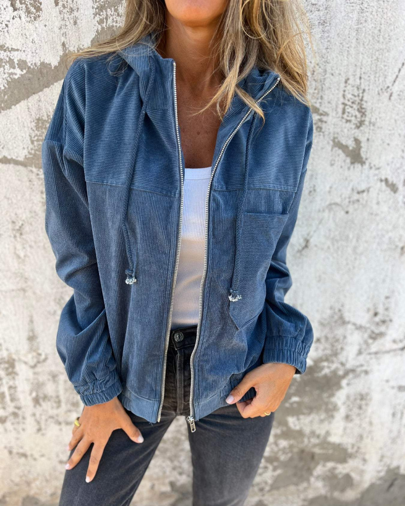 Close-up of the textured corduroy fabric and the silver zipper detail on the Anya jacket.