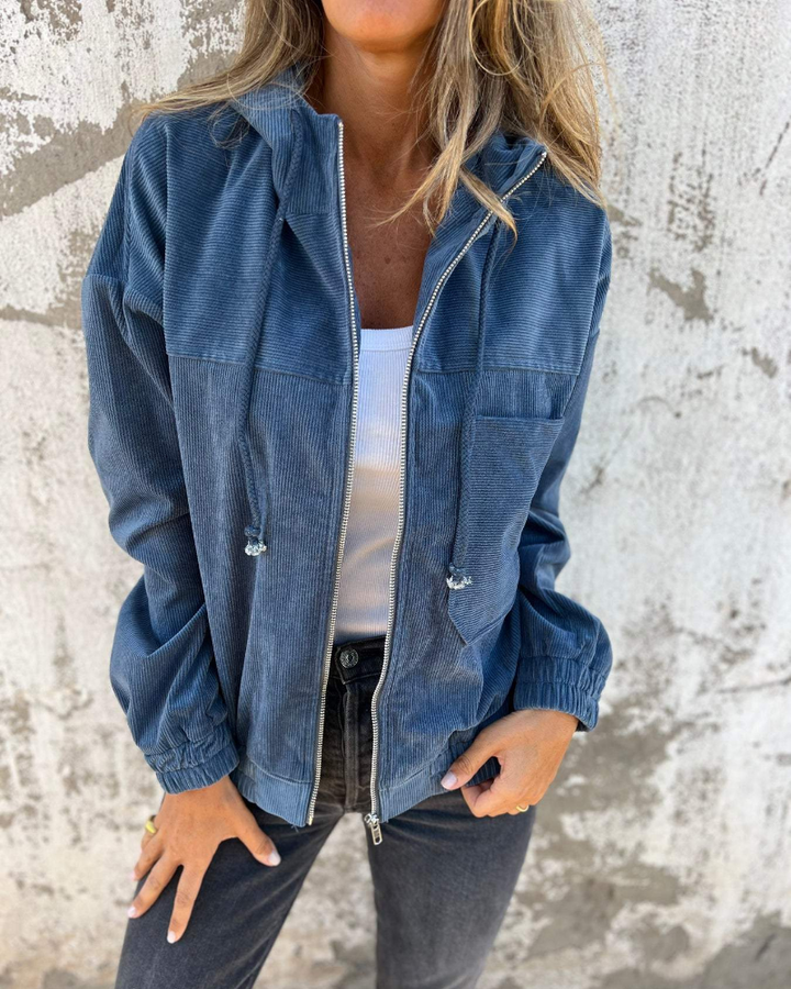 Close-up of the textured corduroy fabric and the silver zipper detail on the Anya jacket.