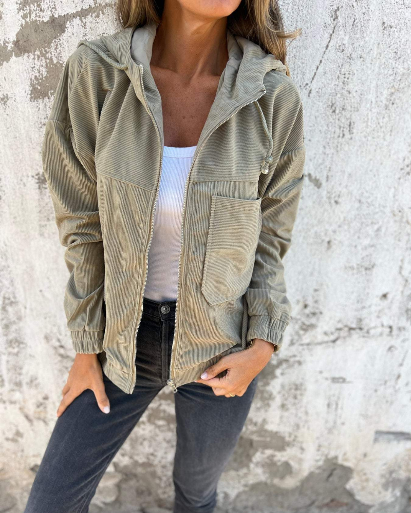 Side profile of a woman in an olive green Anya relaxed corduroy jacket, highlighting the relaxed silhouette and sleeve length.