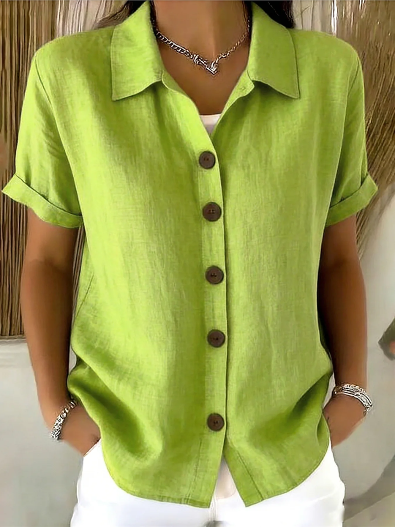Side profile of a woman in a red classic button-up shirt, styled with casual bottoms.