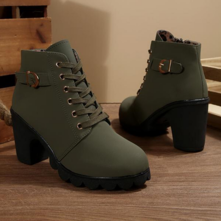 Overhead shot of a pair of black chunky ankle boots, emphasizing the robust sole and textured material.