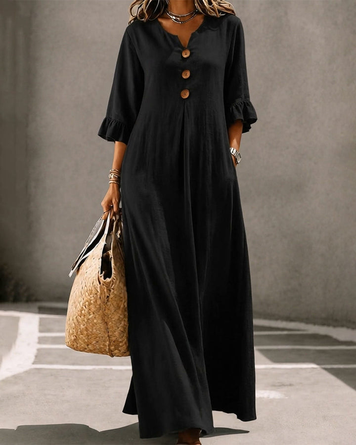Detail shot of the V-neck and button placket on the khaki Calandra maxi dress.