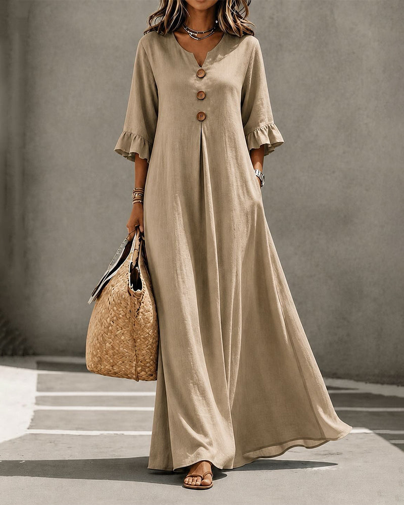 A stack of folded Calandra casual maxi dresses in white, black, and khaki colors.