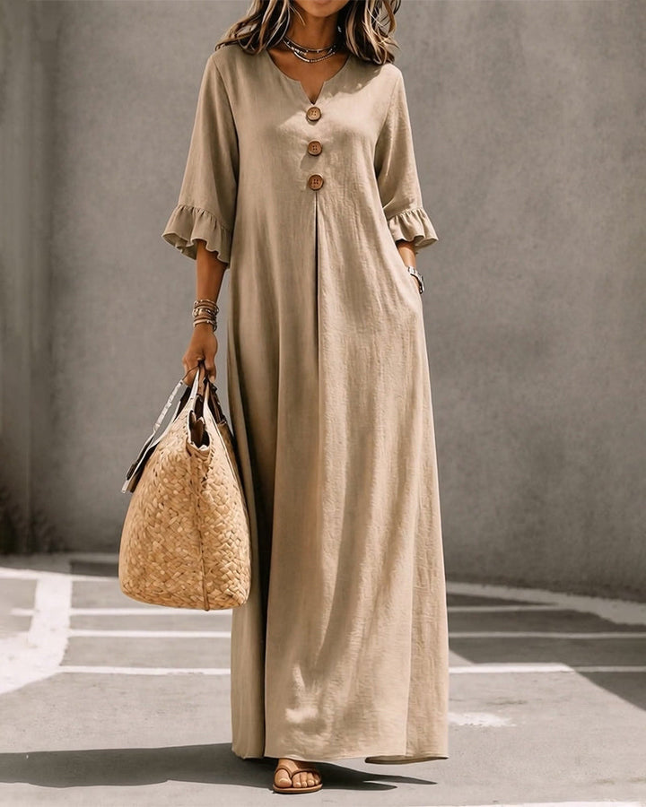 Model posing in the khaki Calandra dress, demonstrating its relaxed fit and half sleeves.