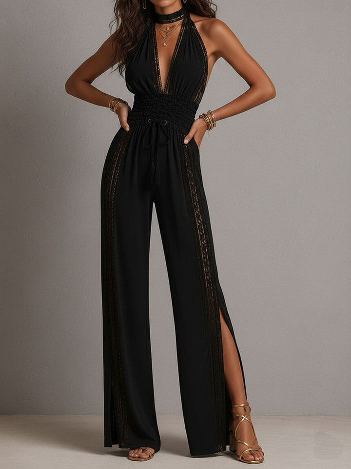 A woman seated, showcasing the comfort and drape of the wide-leg black lace jumpsuit.