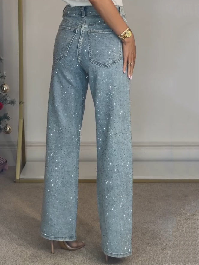 Side profile of a model wearing the high-waisted diamanté straight leg jeans, highlighting the fit and cut.