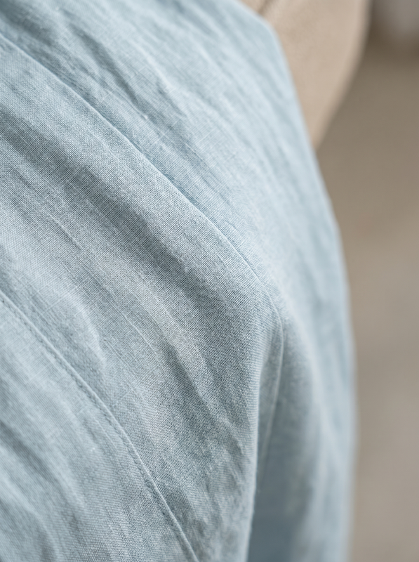 Detail shot of the waist area and pocket design on the military green jumpsuit, highlighting practical features.