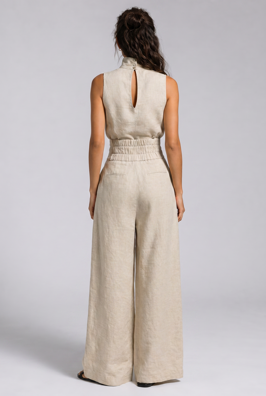 Woman posing in a light pink jumpsuit, demonstrating its flattering fit and comfortable material.