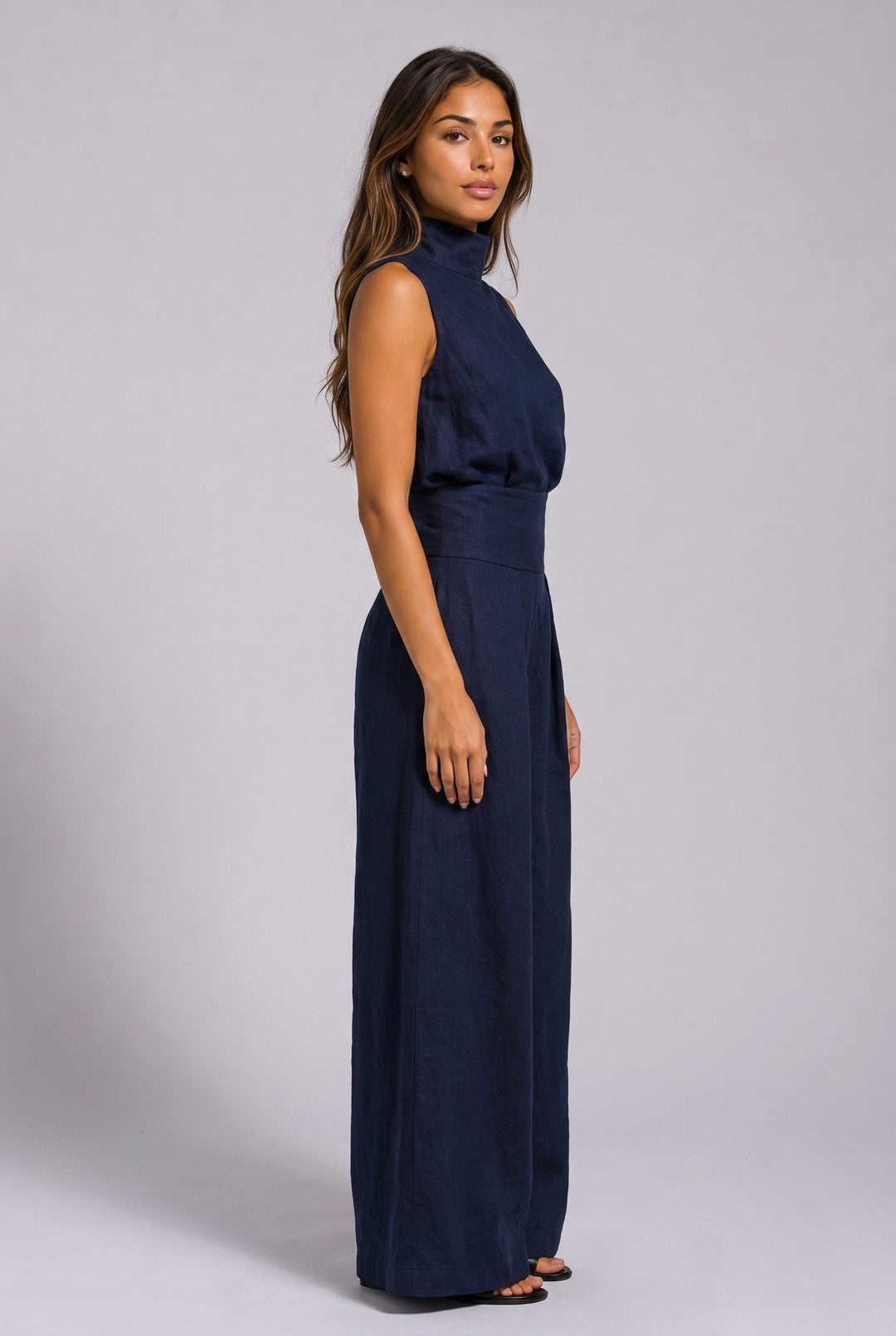 Close-up of the cuff and hem detail on the gray jumpsuit, illustrating the quality finishing of the garment.