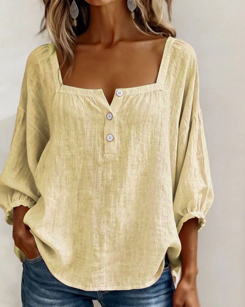 A gray square neck blouse displayed against a neutral background, emphasizing its versatility.