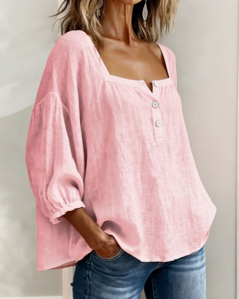 Close-up of the square neckline and button details on a pink cotton linen blouse.