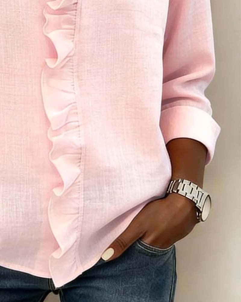 Side profile of a model wearing the pink ruffled V-neck blouse, highlighting its flowy silhouette.