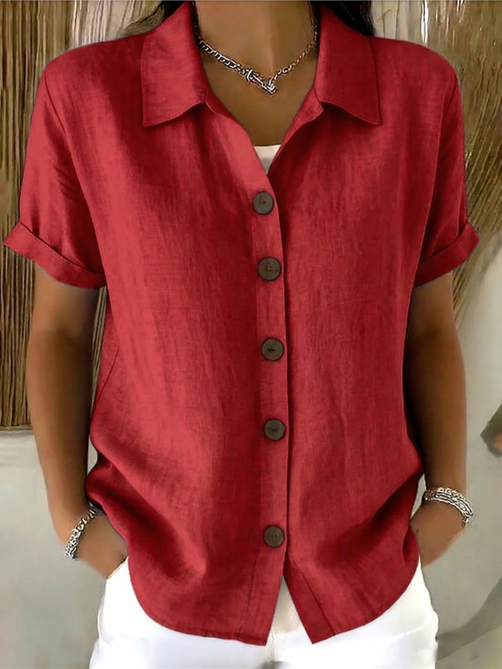 Rear view of the white button-front shirt, showing the smooth fabric and clean lines from behind.