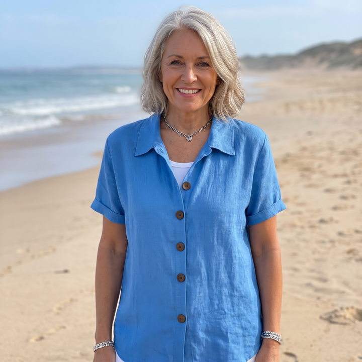 Texture shot of the cotton blend fabric of the white button-front shirt, emphasizing its soft and breathable quality.