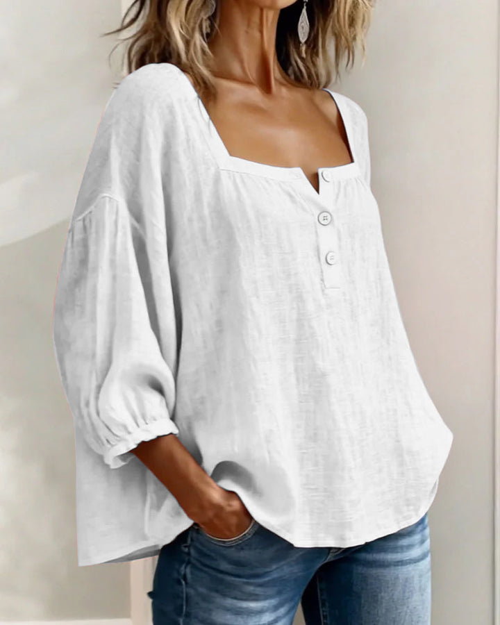 A blue square neck blouse paired with a skirt, suitable for a relaxed summer gathering.