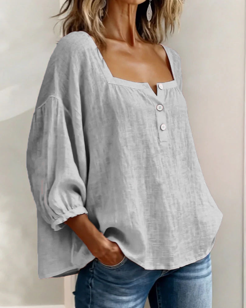 A yellow square neck blouse hanging outdoors, suggesting its suitability for sunny days.