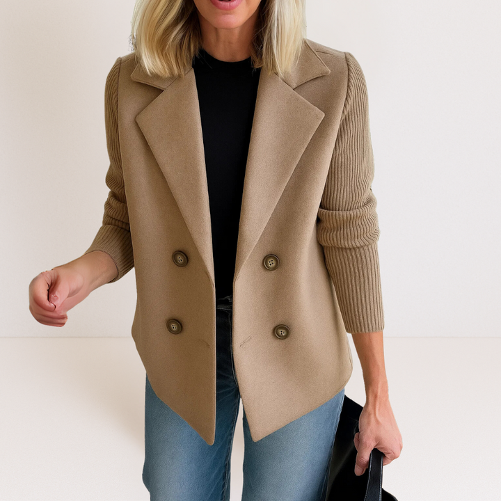 Front view of the Evadne knit sleeve blazer in black worn by a model, showing the tailored fit and knit sleeves.