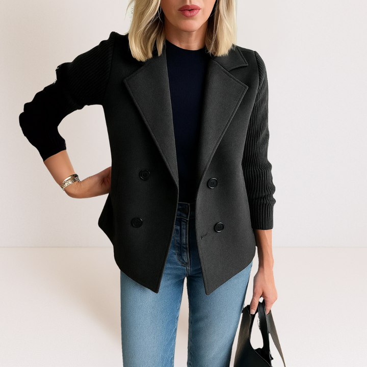 Back view of the navy blue Evadne knit sleeve blazer, displaying its clean lines and elegant drape on a mannequin.