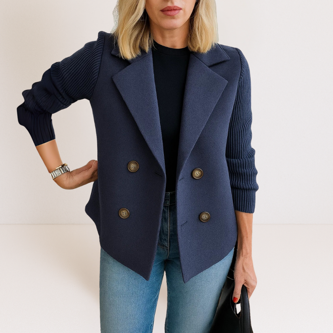 Detail of the single-button closure and notched lapel on the light blue Evadne knit sleeve blazer.