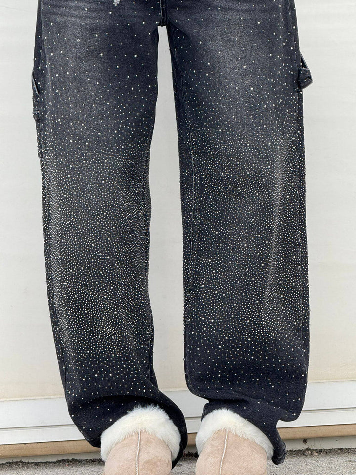 Back view of the black embellished carpenter jeans, emphasizing the overall silhouette.