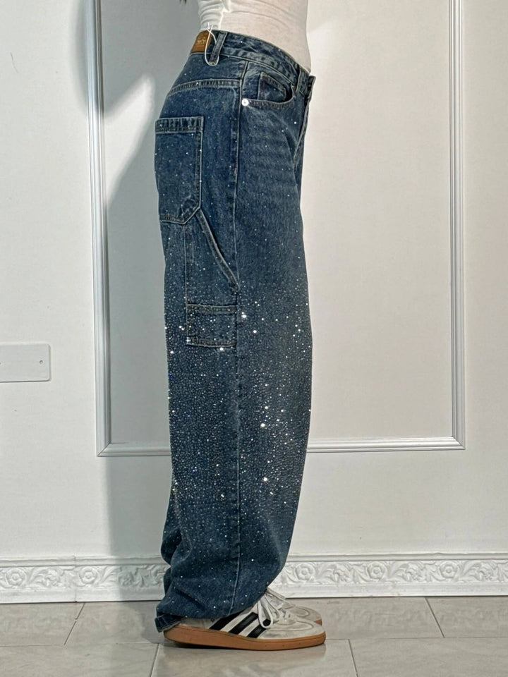Close-up of the super shine jewel applications on the dark blue carpenter jeans fabric.