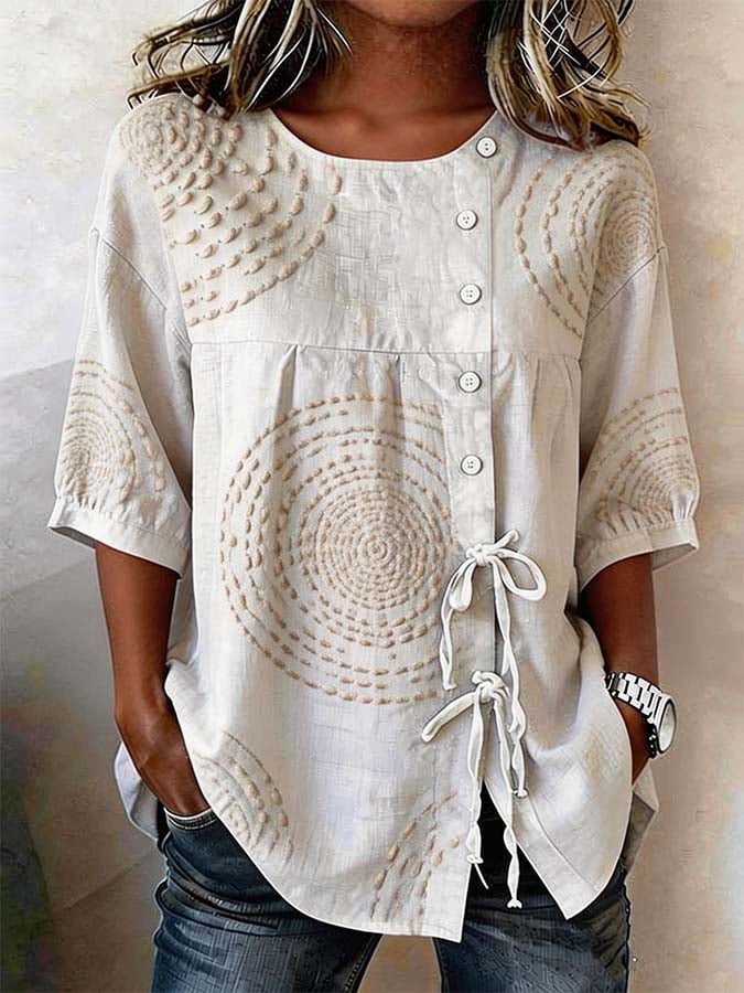 Front view of the Isolde artisan embroidered top in cream, showcasing its unique textured circular patterns and relaxed fit.
