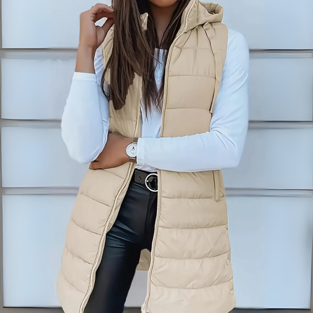Close-up detail of the quilted pattern on the black puffer vest fabric, showing texture.