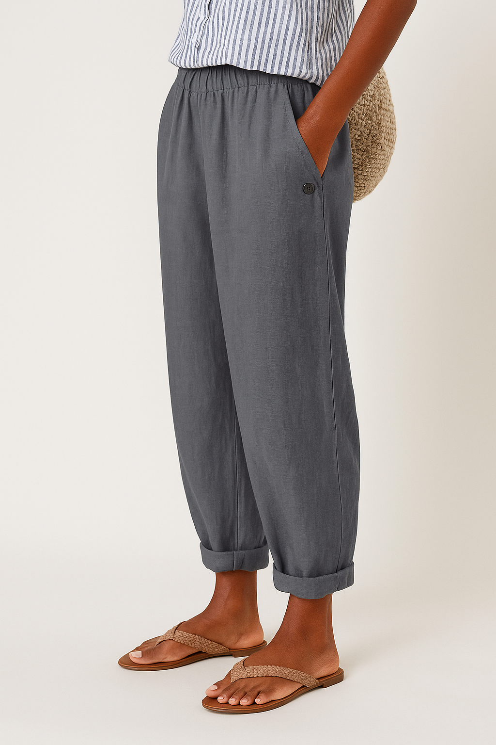 Lifestyle shot of a woman wearing Kailani comfortable pants, paired with a simple top, walking outdoors.