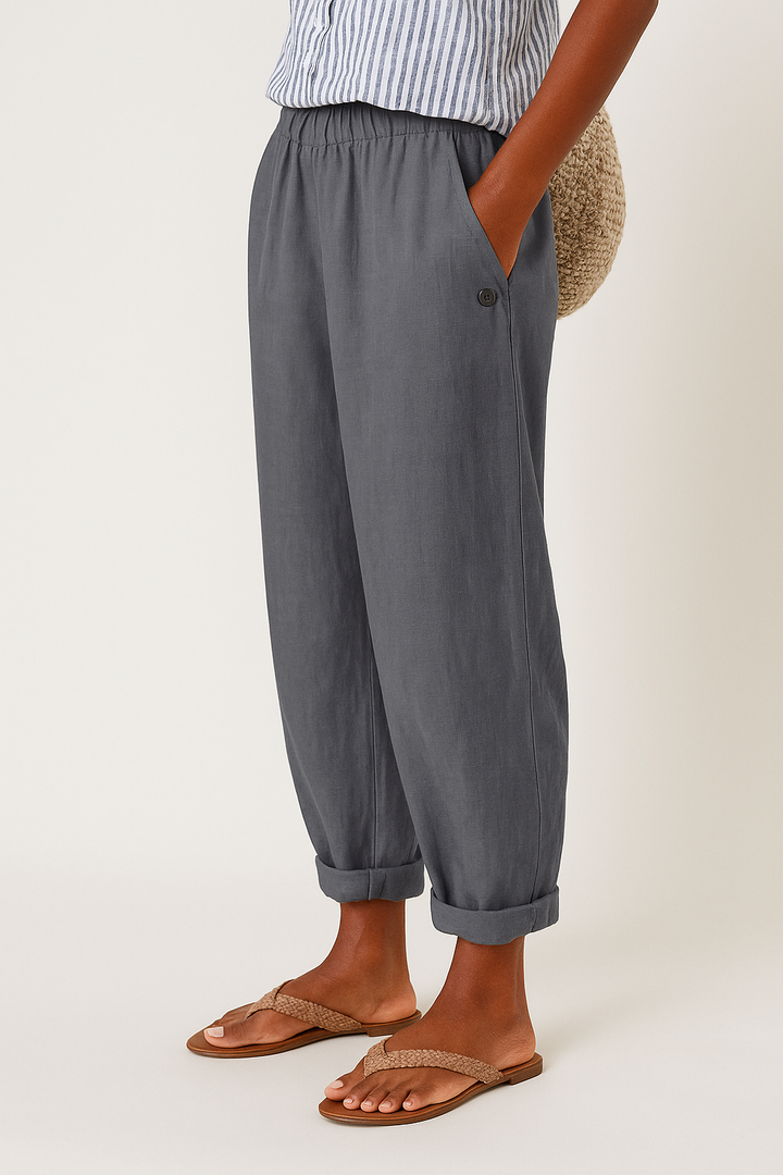 Lifestyle shot of a woman wearing Kailani comfortable pants, paired with a simple top, walking outdoors.