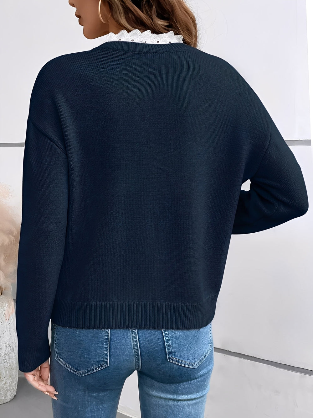 Side profile of the Kaitlyssa sweater in gray, highlighting the comfortable fit and versatile design.