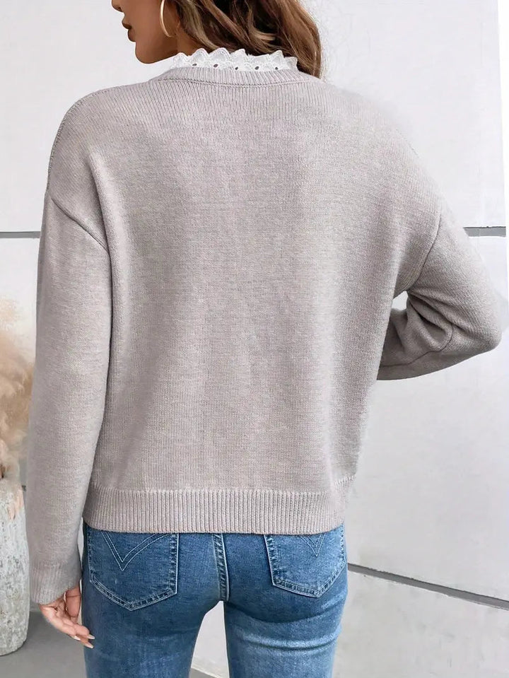 The Kaitlyssa elegant sweater laid flat, displaying its full design and smooth texture.