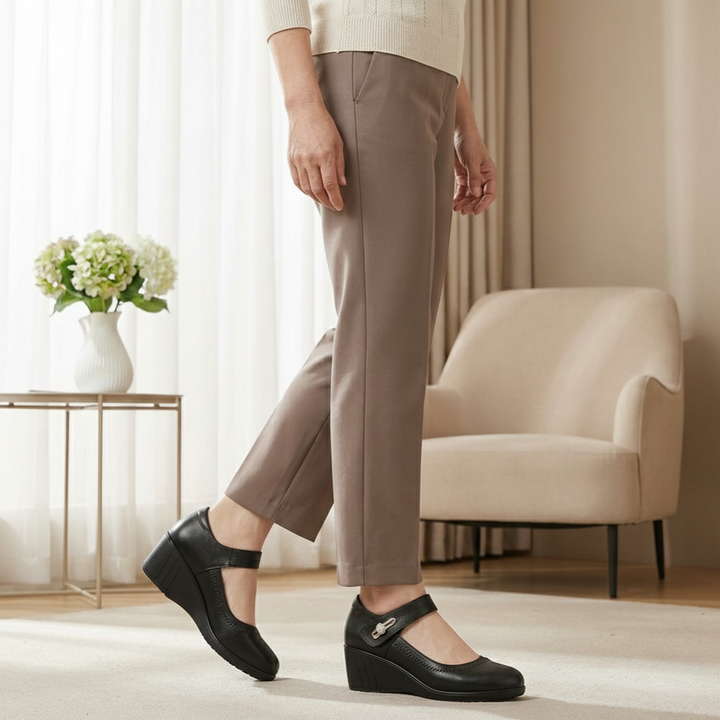 Side profile of Kiana everyday trousers in beige, highlighting the relaxed yet tailored silhouette.