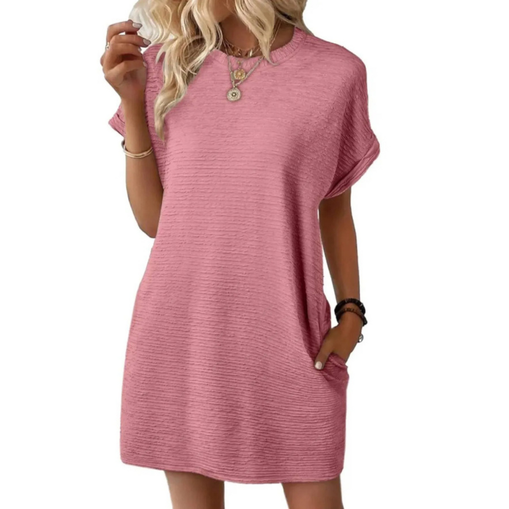 Side profile of the Kira casual summer dress on a model, highlighting the minimalist design and comfortable fit.