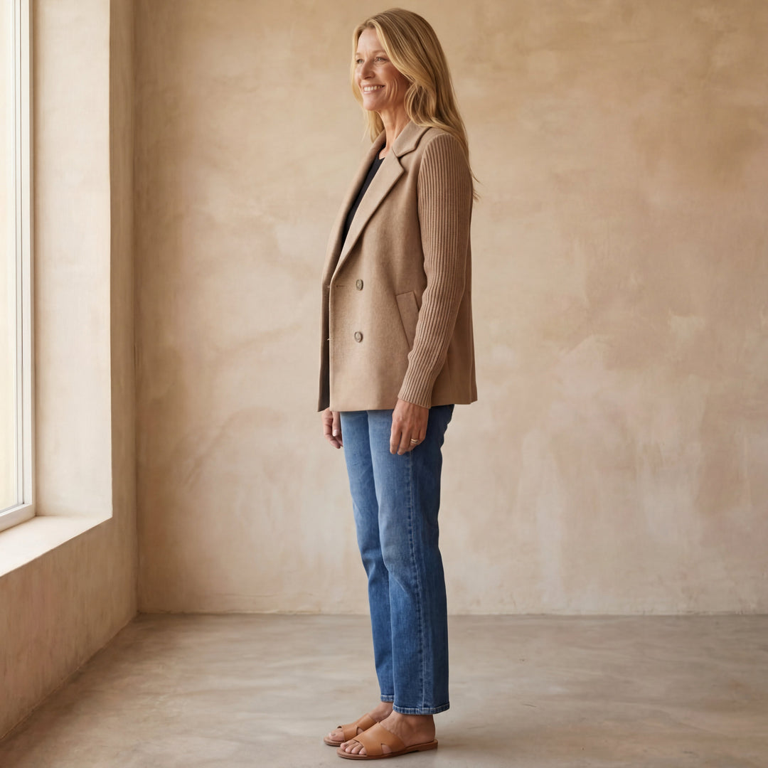 Side profile of a model wearing the gray Kira women's casual jacket, styled with pants.