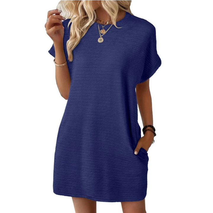 Back view of the Kira casual summer dress, showcasing its flowing silhouette and simple elegance.