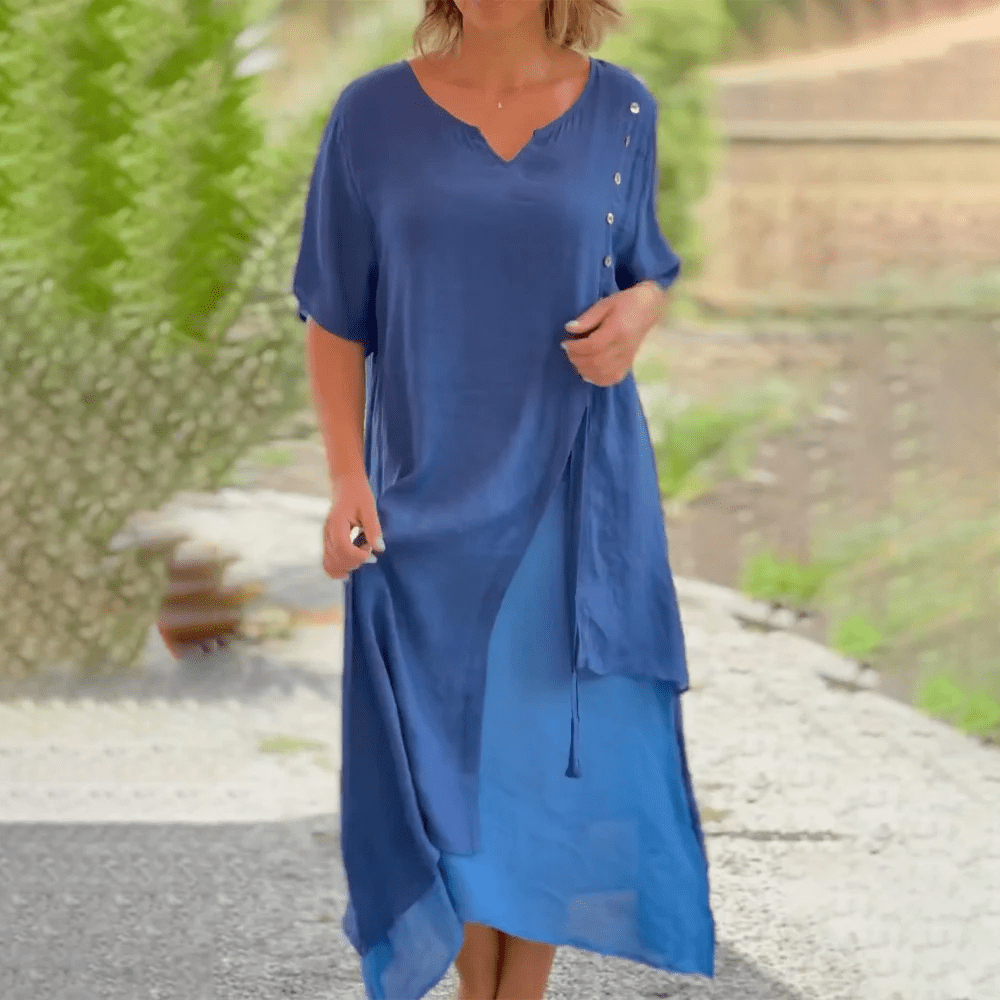 Graceful woman wearing a blue Liana classic maxi dress, shown from the front.