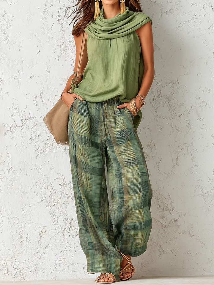 Model wearing Lyra relaxed wide-leg trousers in a full-length, front-facing outdoor shot.