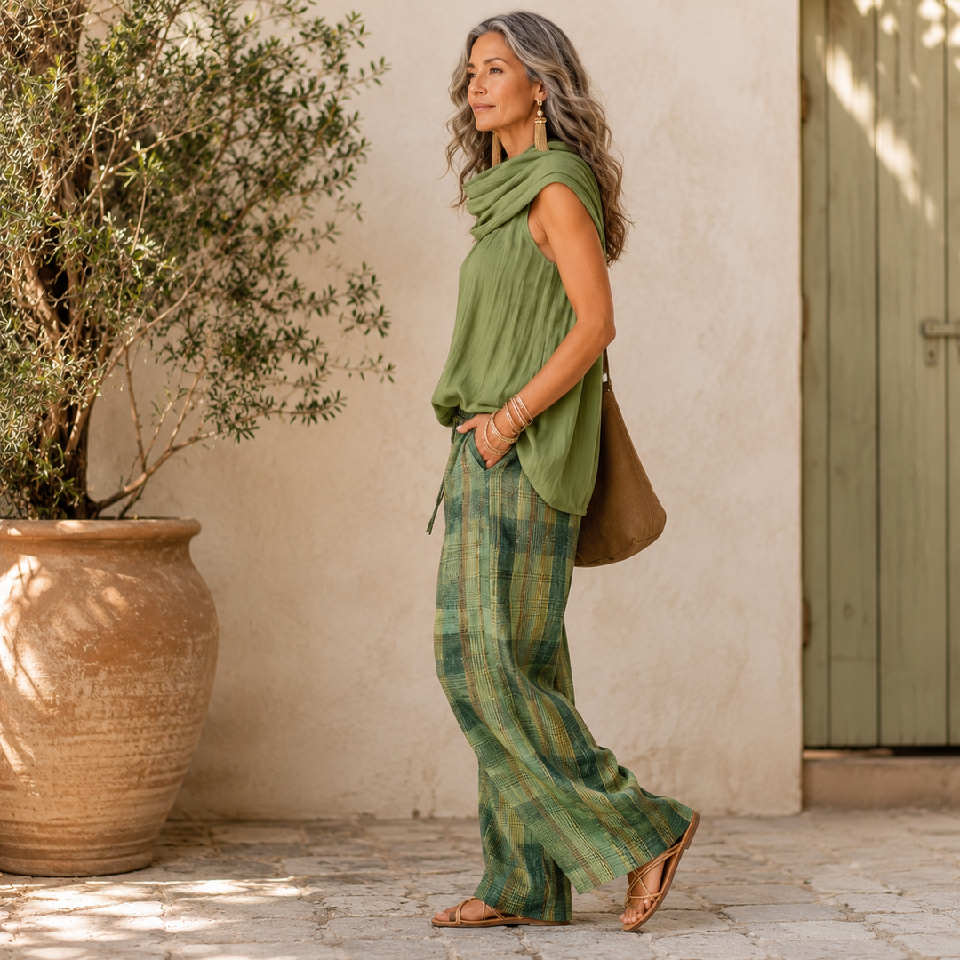 Model showcasing the comfortable drape and movement of the Lyra wide-leg trousers from a side angle.