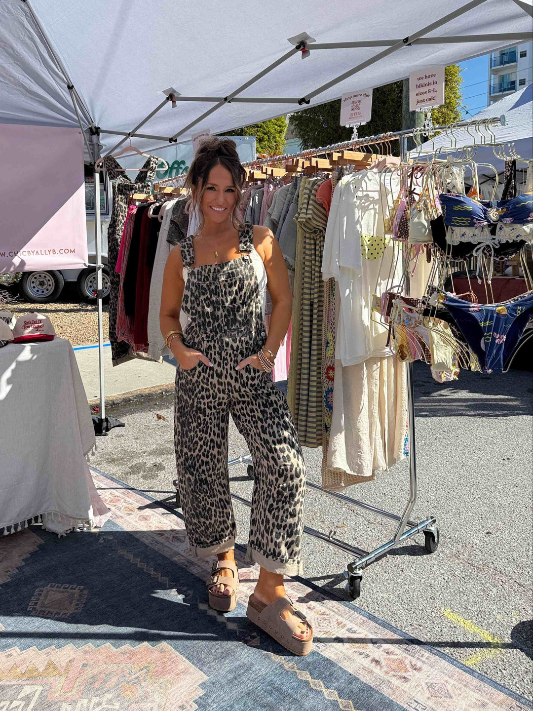 Front view of women's leopard print overalls, showcasing the square neckline and adjustable straps.