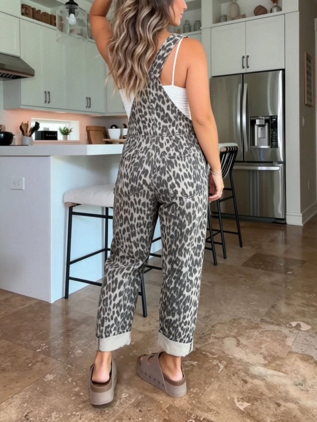 Model wearing the comfortable leopard print overalls in a casual outdoor setting, showing the full length.