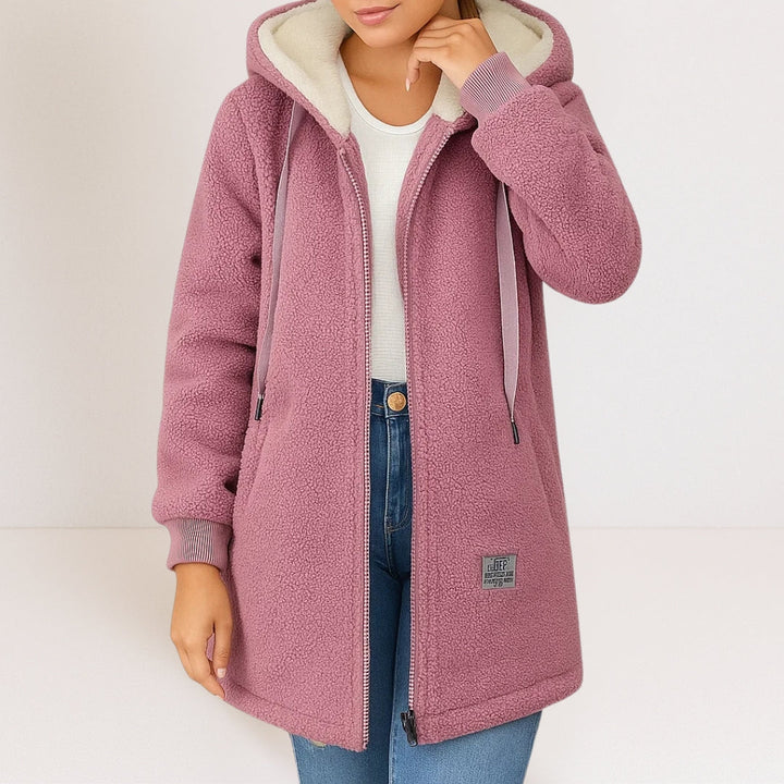 Close-up detail of the zip-front closure and the cozy fleece material of the pink women's fleece jacket.