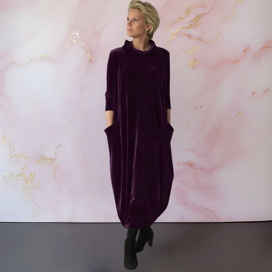 Lifestyle shot of the Rosalind velvet maxi dress in red, worn outdoors for a chic look.