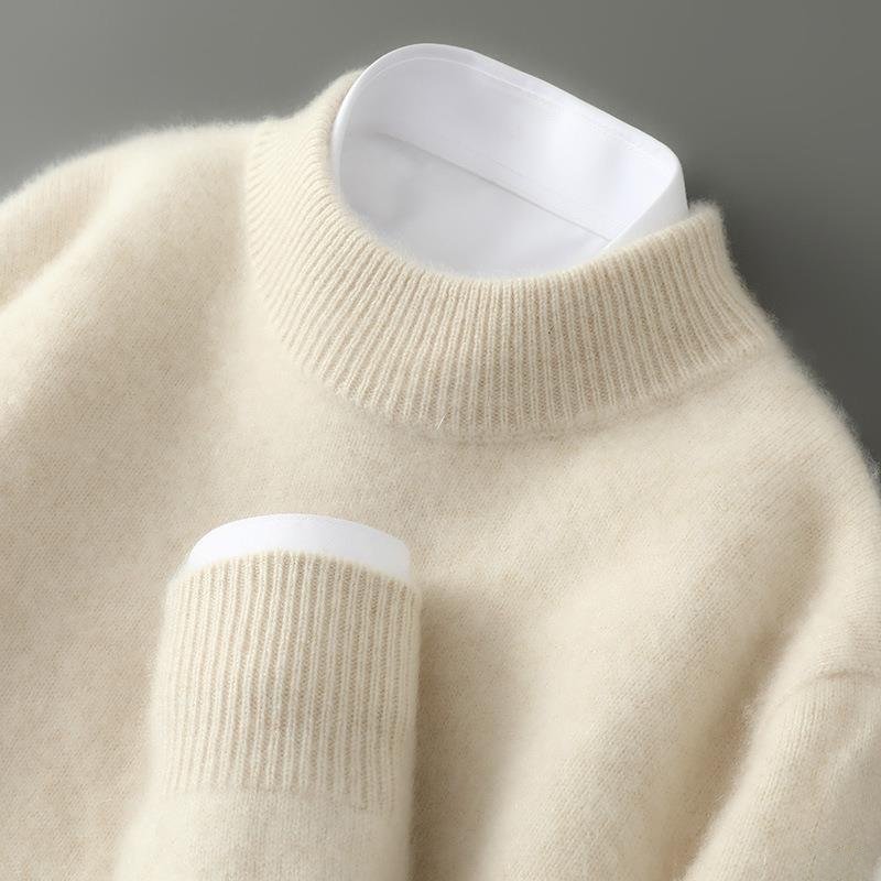 Front view of a cream cashmere sweater draped elegantly on a mannequin, showcasing its soft texture.