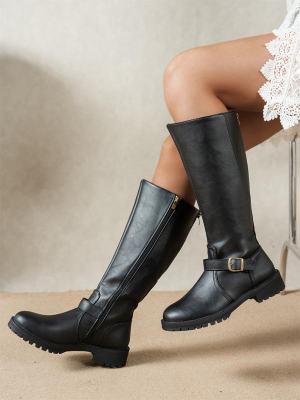 A woman wearing Seraphina classic low heel boots with jeans and a sweater, demonstrating their versatility for a stylish fall outfit.